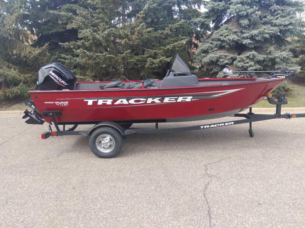Tracker Pro Guide V-16 SC 2025 Tracker Pro Guide V-16 SC boat on trailer, red color, parked outdoors.
