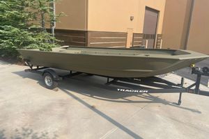 Tracker Grizzly 2072 Utility 2026 Tracker Grizzly 2072 Utility boat on trailer, parked outdoors near building.