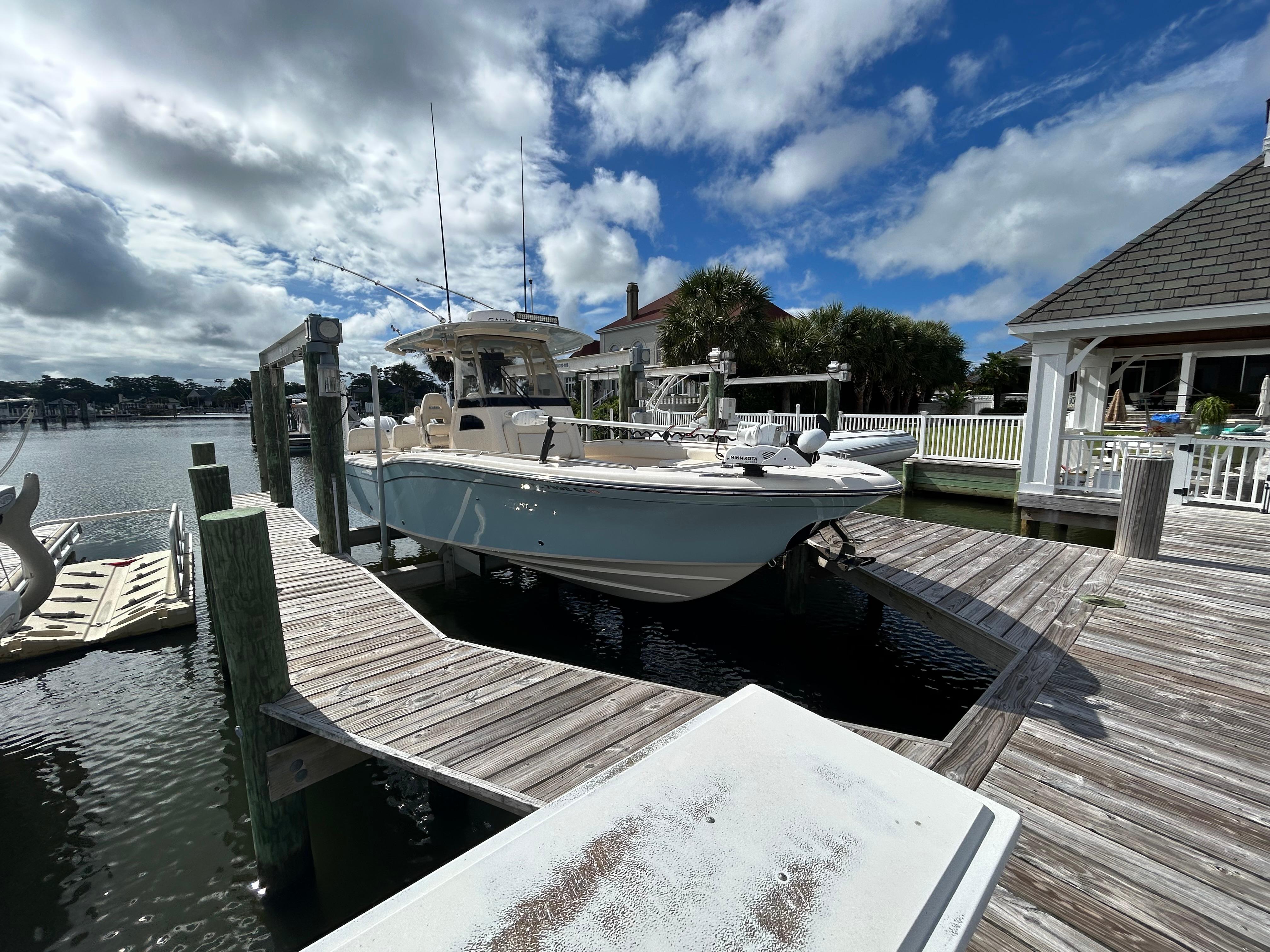 Grady-White 281 Coastal Explorer 2023 Grady-White 281 Coastal Explorer docked under a partly cloudy sky.