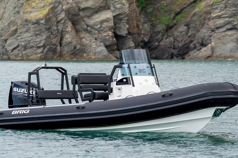 Brig Navigator 20 2026 Brig Navigator 20 boat with Suzuki engine on calm water near rocky shore.