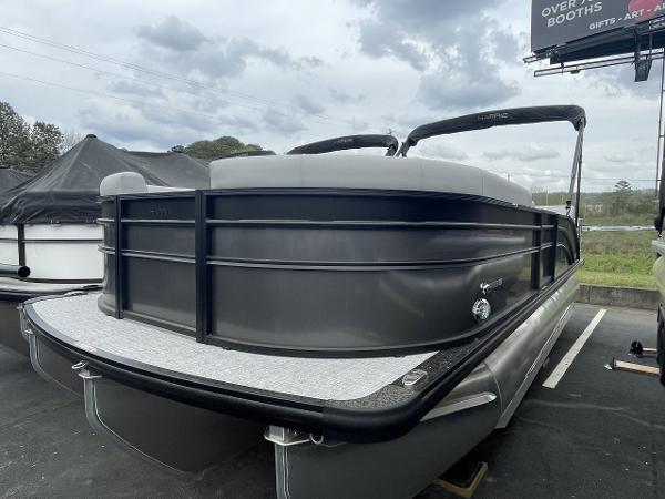Harris Cruiser 230 2025 Harris Cruiser 230 pontoon boat in a parking lot under cloudy skies.