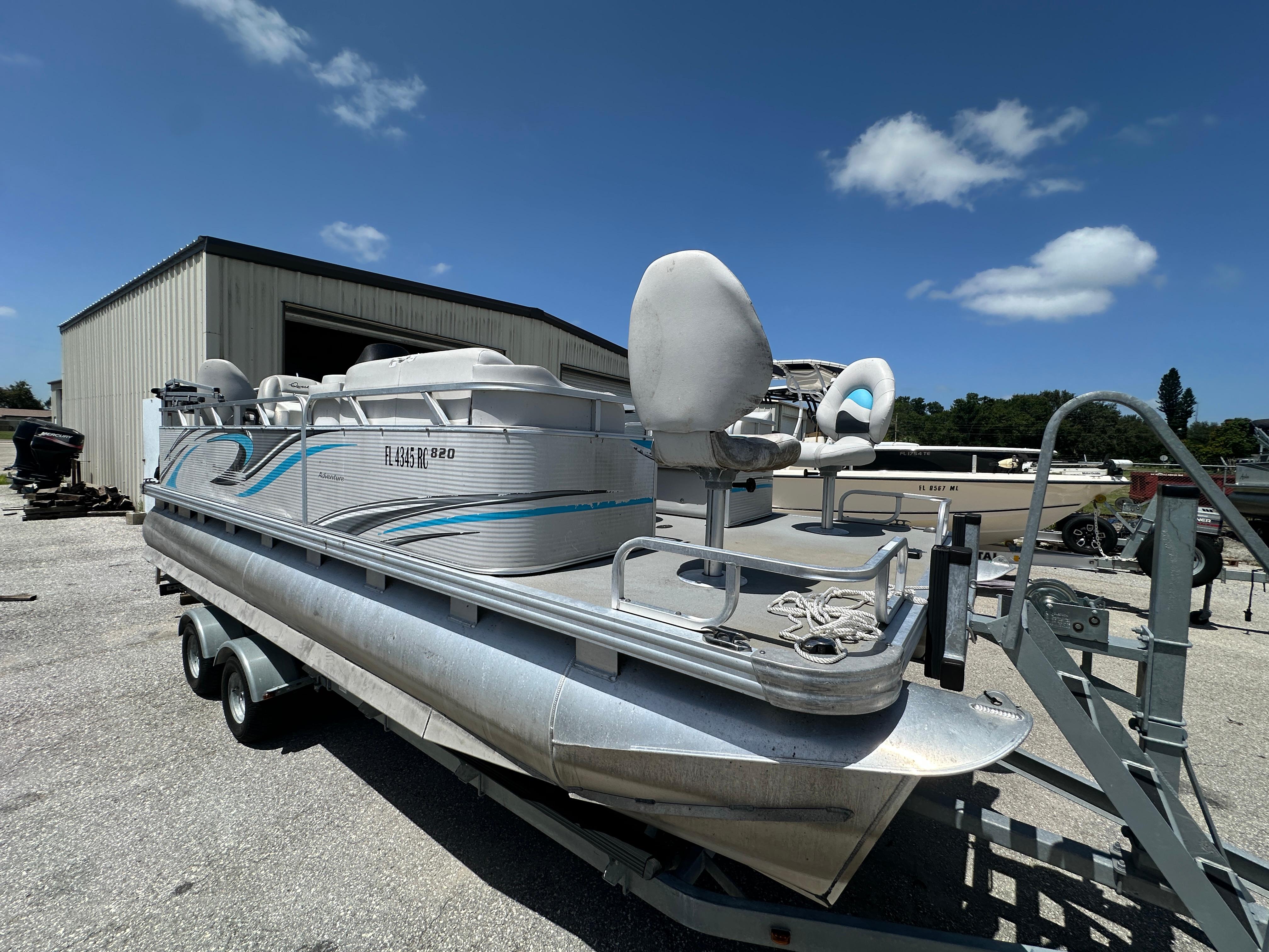 Qwest Adventure 820 VX Fish 2016 Qwest Adventure 820 VX Fish pontoon boat on trailer, parked outdoors under blue sky.
