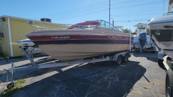 Cobalt Condesa 1987 Cobalt Condesa boat on trailer, parked outdoors in a sunny setting.