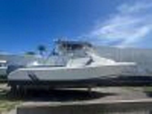 Cobia Walk-around 1998 Cobia Walk-around boat on display under a clear blue sky.