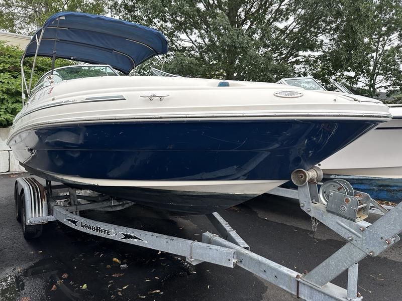 Sea Ray 220 Sundeck 2006 Sea Ray 220 Sundeck boat on trailer with blue canopy, parked outdoors.