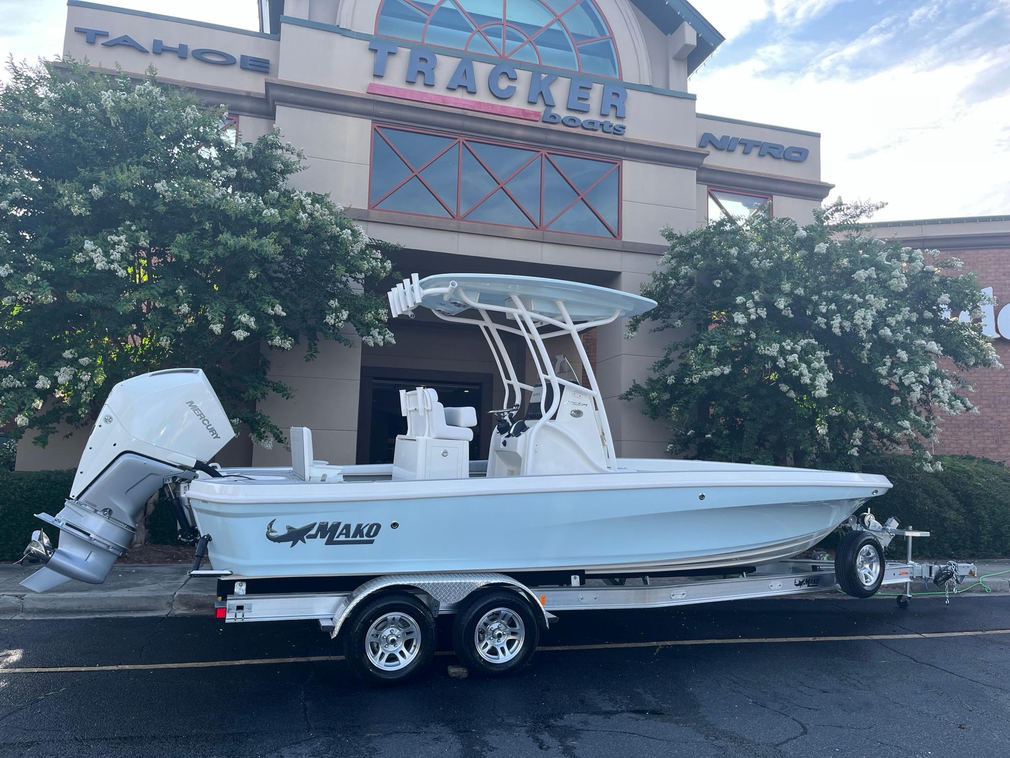 Mako 24 APEX 2025 Mako 24 APEX boat on trailer outside Tracker Boats dealership.