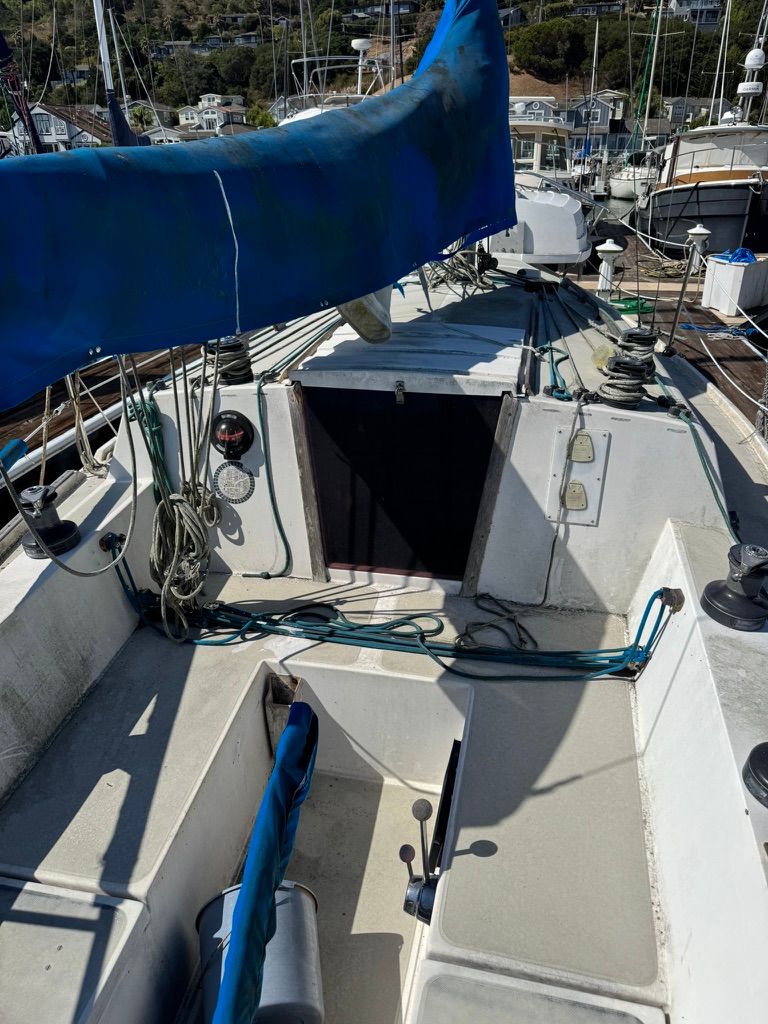Sailboat jense 1978 Jense sailboat deck with blue sail cover and rigging.