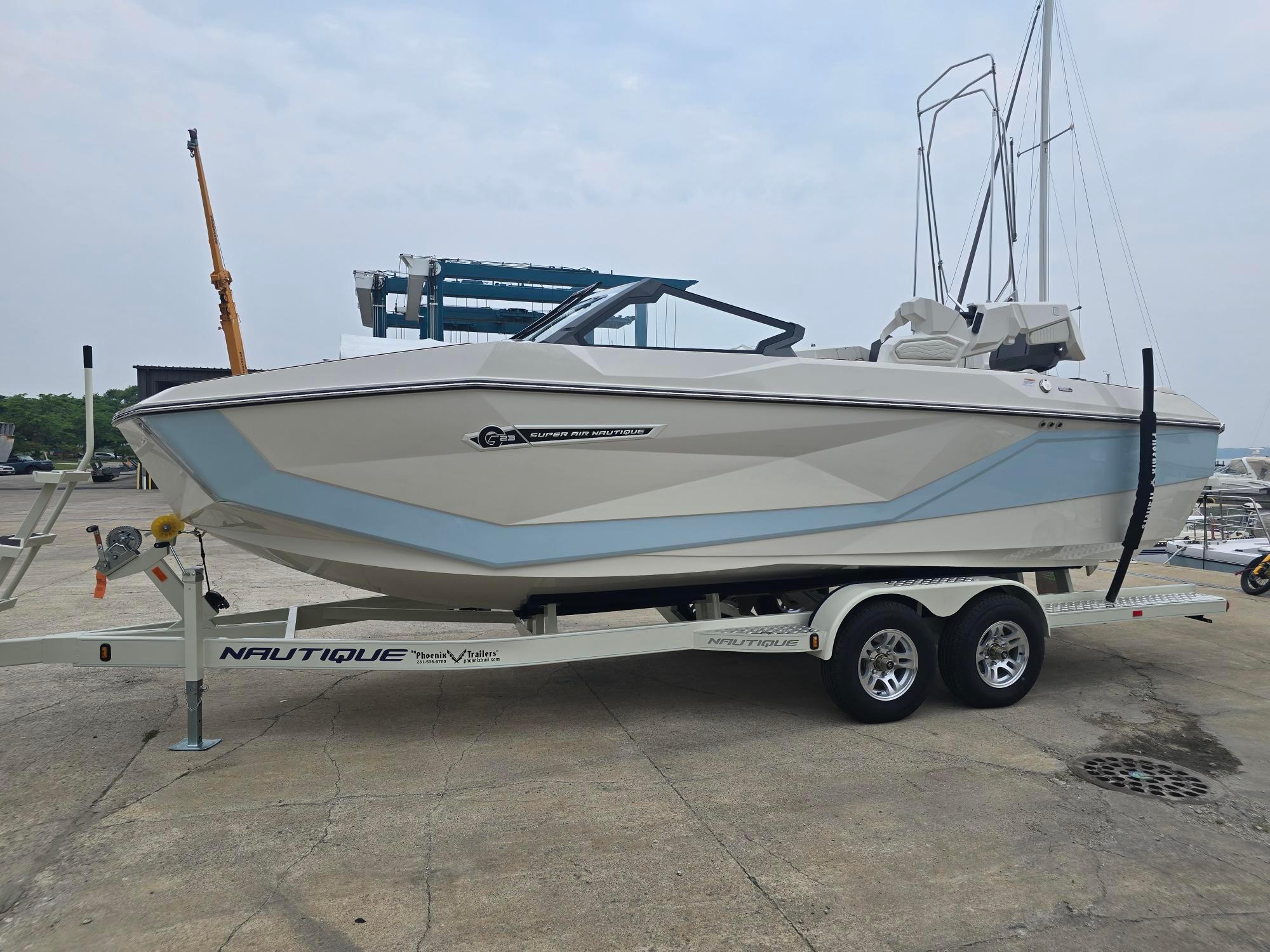 Nautique Super Air Nautique G23 2026 Nautique Super Air Nautique G23 boat on trailer at marina.
