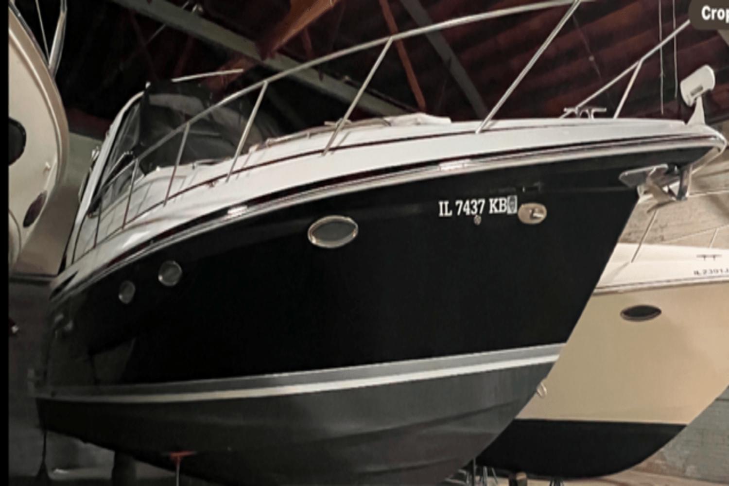Formula 34 PC 2005 Formula 34 PC boat in storage, black hull, side view.