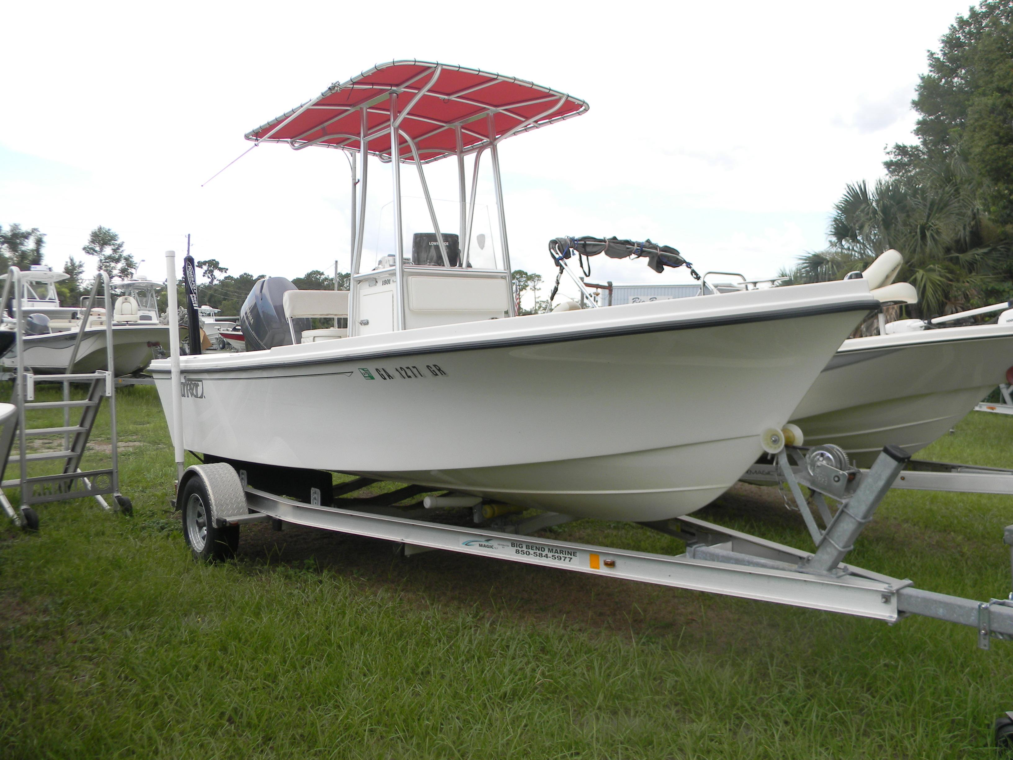Parker 1801 Center Console 2014 Parker 1801 Center Console boat on trailer with red canopy, parked on grass.