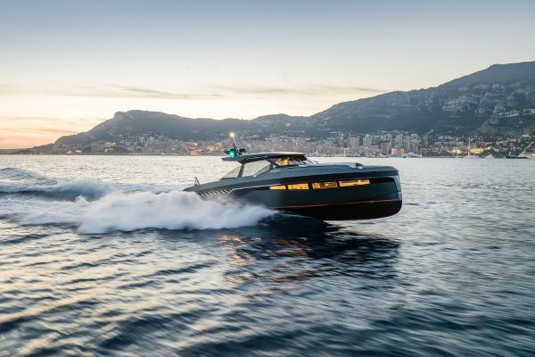Bekkers Yachts Azur 45HT Bekkers Yachts Azur 45HT 2023 cruising on water at sunset near coastal city.