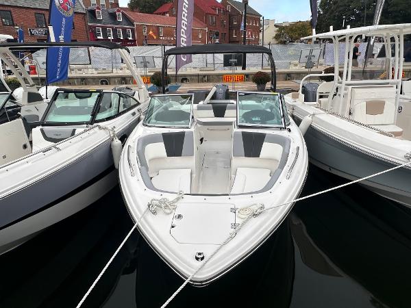 Chaparral 23 SSi OB 2025 Chaparral 23 SSi OB boat docked, showcasing sleek design and spacious seating.