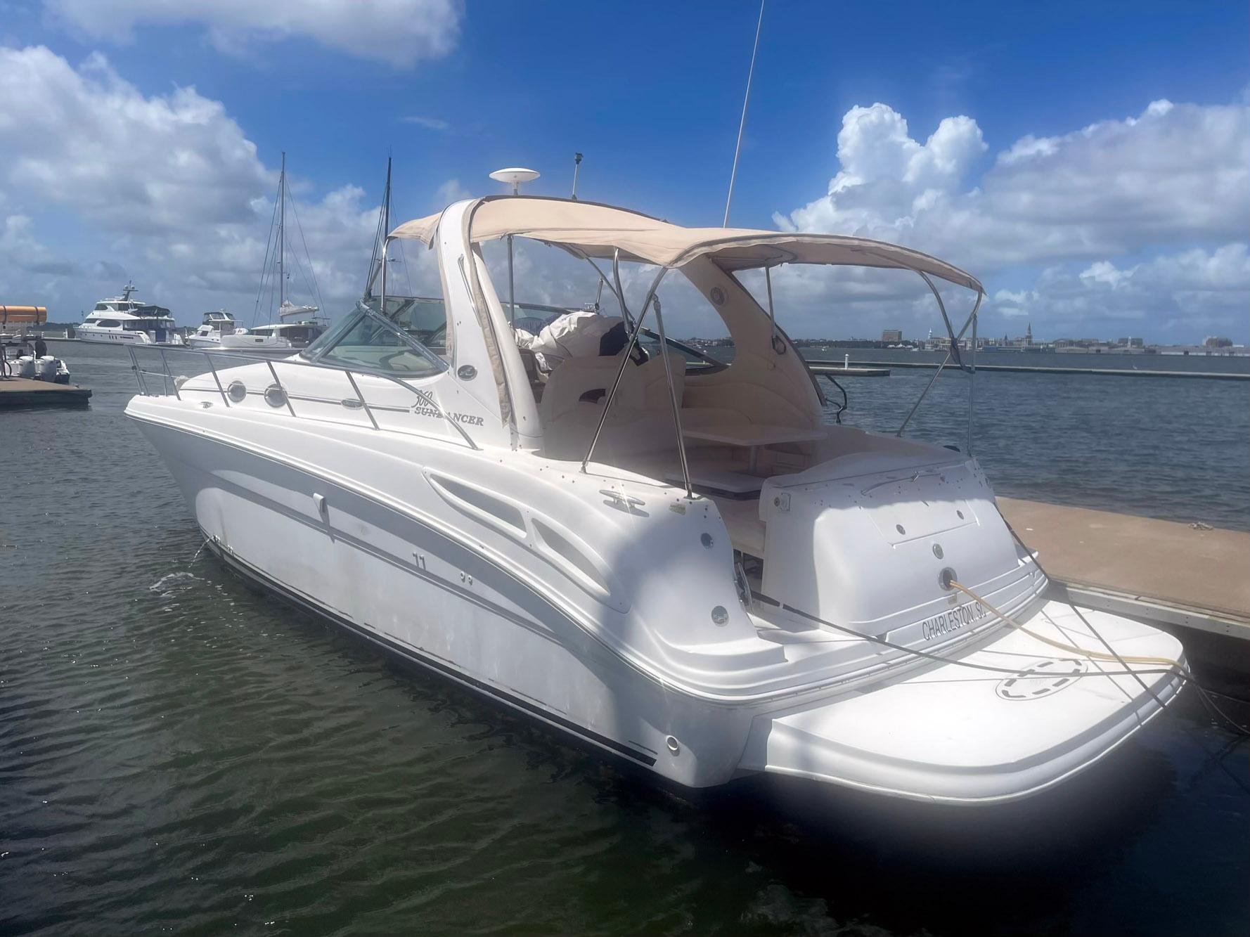 Sea Ray 360 Sundancer 2003 Sea Ray 360 Sundancer yacht docked at marina under blue sky.