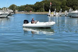 Mercury Inflatables M 400 HP 2018 Mercury Inflatables M 400 HP boat on calm water near a marina.