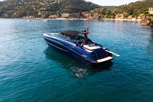 Riva 63 Virtus Luxurious 2015 Riva 63 Virtus yacht cruising in scenic coastal waters.