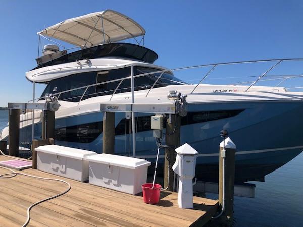 Regal 42 Fly 2018 Regal 42 Fly yacht docked at a marina under clear blue skies.