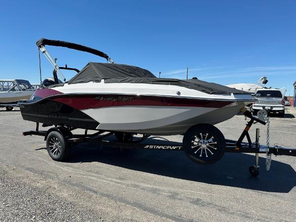 Starcraft SVX 190 OB DC 2024 Starcraft SVX 190 OB DC boat on trailer, covered and parked outdoors.