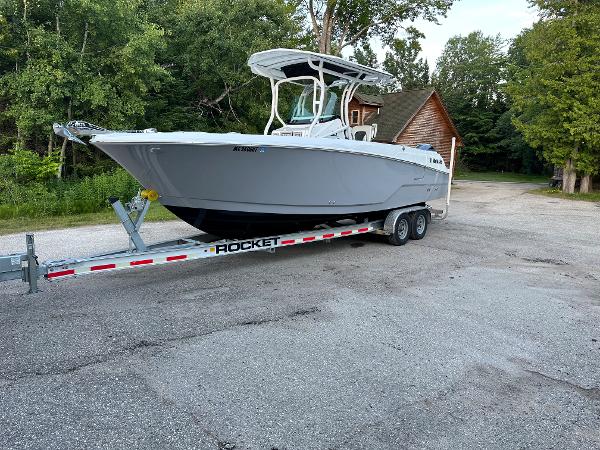 Wellcraft 262 Fisherman 2021 Wellcraft 262 Fisherman boat on a Rocket trailer in a wooded area.