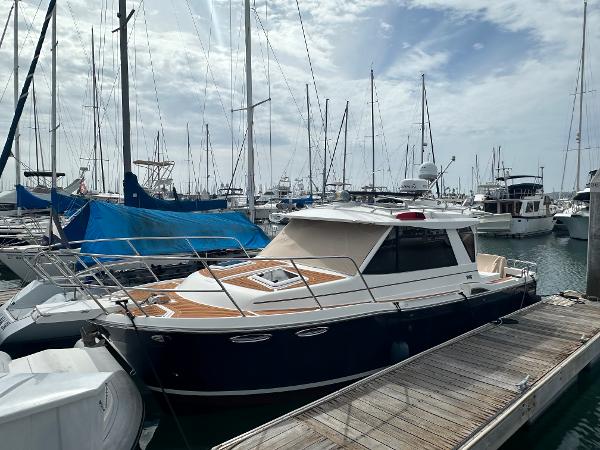 Cutwater 28 2016 Cutwater 28 boat docked in a marina, surrounded by other vessels.