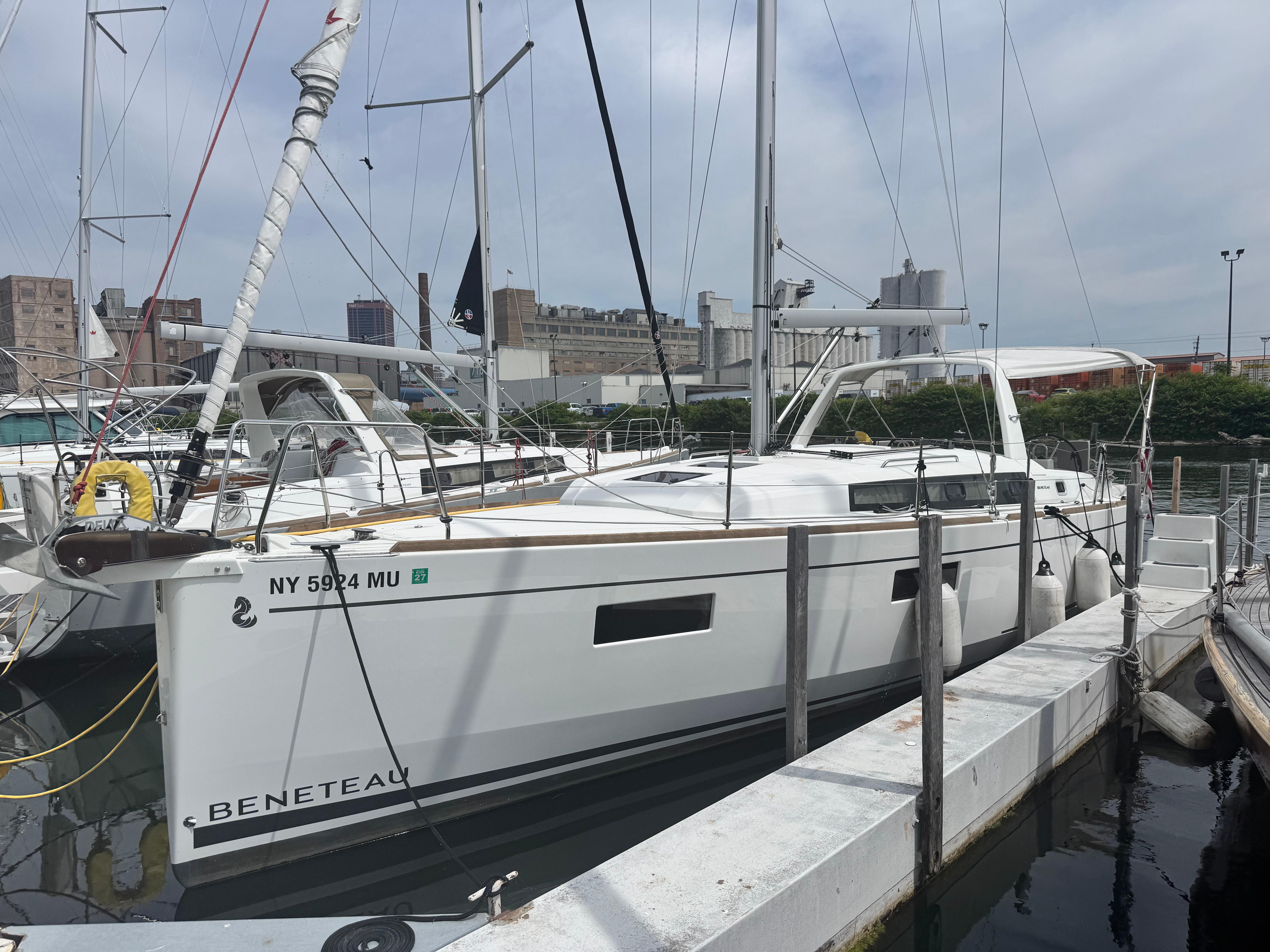 Beneteau Oceanis 38.1 2023 Beneteau Oceanis 38.1 sailboat docked at marina, side view.