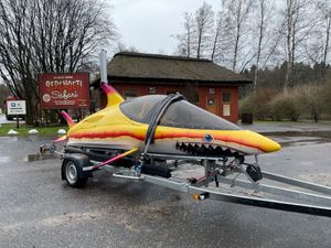 Custom Seabreacher x/151 Colorful 2021 Custom Seabreacher x/151 resembling a shark, parked near Serengeti Safari sign.