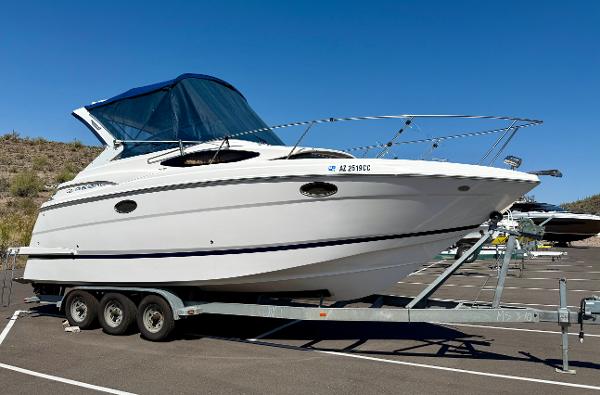 Regal 2860 Window Express 2007 Regal 2860 Window Express boat on trailer in parking lot.
