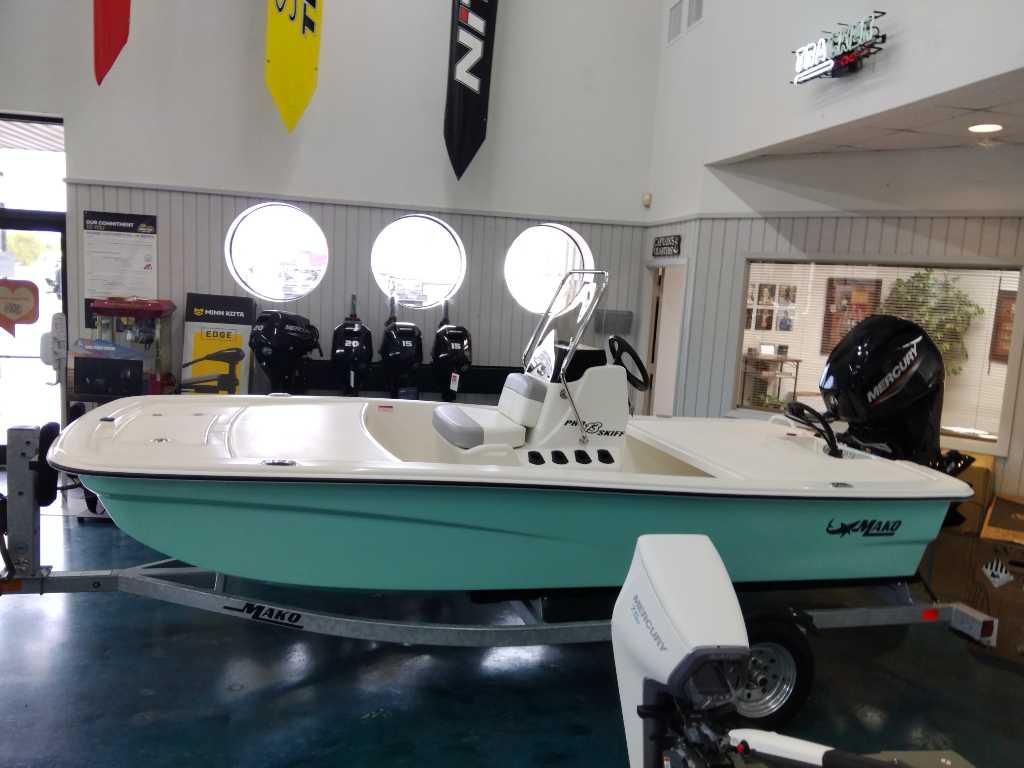 Mako Pro Skiff 13 CC 2024 Mako Pro Skiff 13 CC boat displayed indoors on a trailer.