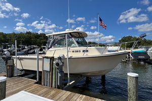 Parker 2510 XL Walkaround 2011 Parker 2510 XL Walkaround boat docked at marina under blue sky.