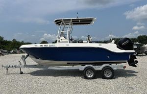 Bayliner Trophy T20CX 2022 Bayliner Trophy T20CX boat on trailer, blue and white design, parked outdoors.