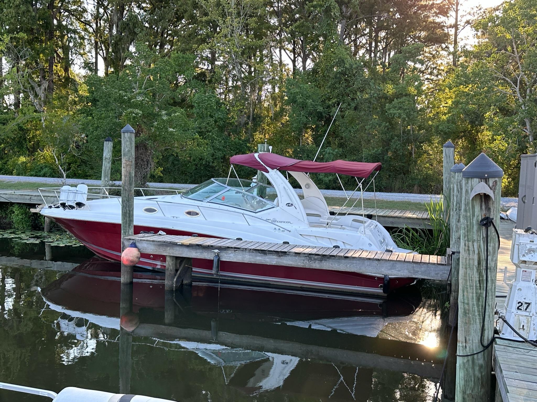 Sea Ray 340 Sundancer 2006 Sea Ray 340 Sundancer docked at a marina with lush green trees in the background.