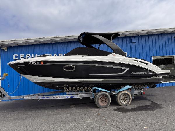Chaparral 257 SSX 2013 Chaparral 257 SSX boat on trailer, parked outside blue building.