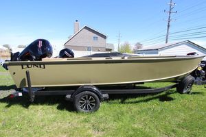 Lund 2075 Alaskan Tiller 2025 Lund 2075 Alaskan Tiller boat on trailer, parked on grass.
