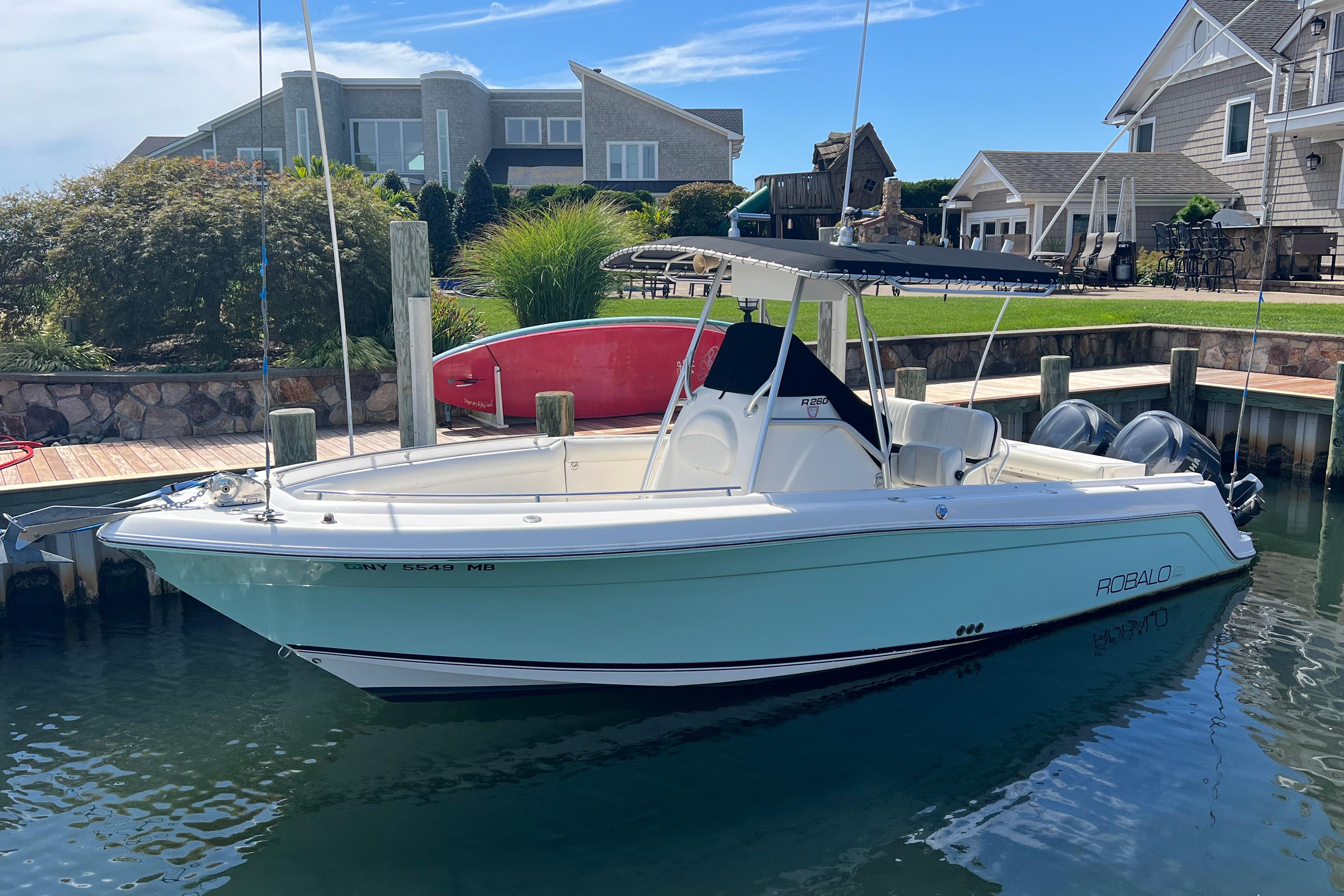 Robalo R260 Center Console 2004 Robalo R260 Center Console boat docked near waterfront homes.
