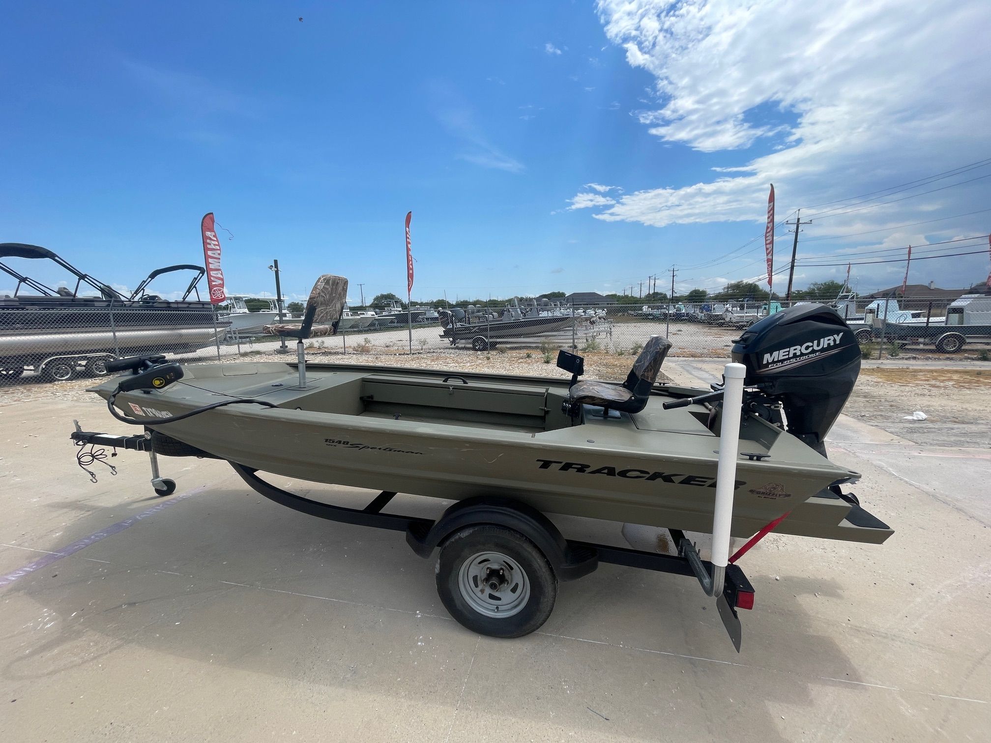 Tracker Sportsman 1548 2019 Tracker Sportsman 1548 boat with Mercury engine on trailer, outdoor dealership setting.
