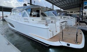 Riviera 505 SUV 2024 Riviera 505 SUV luxury yacht docked at marina, showcasing sleek design and spacious deck.