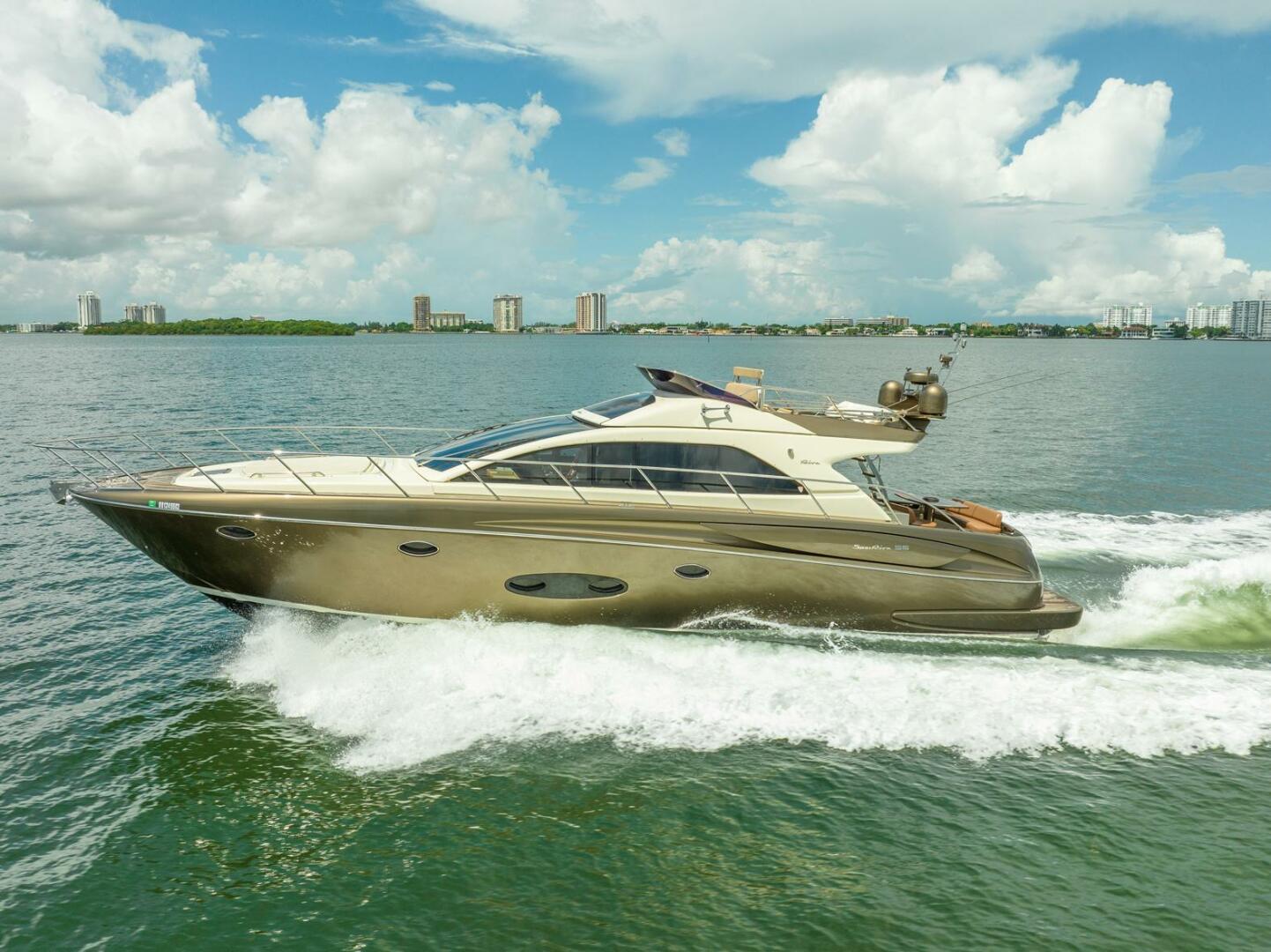 Riva Sport 56 Luxurious 2012 Riva Sport 56 yacht cruising on open water under a clear sky.