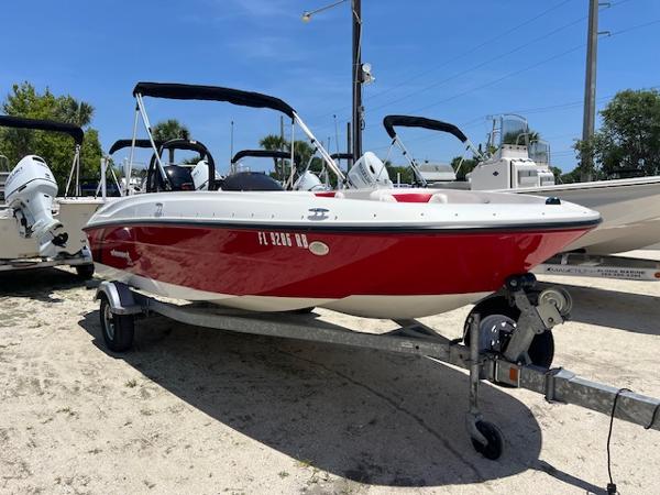 Bayliner Element XL 2016 Bayliner Element XL boat in red, parked on a trailer under a clear blue sky.