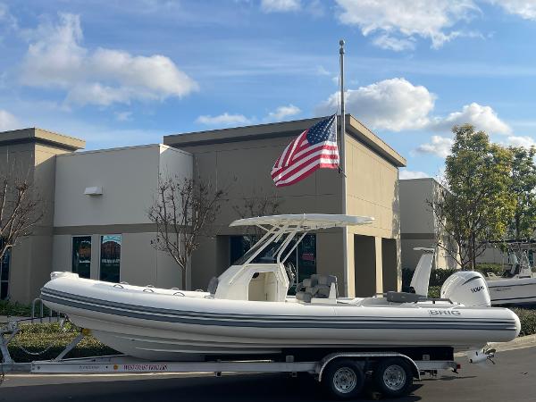 Brig Eagle 8 2025 Brig Eagle 8 boat on trailer, American flag, modern building background.