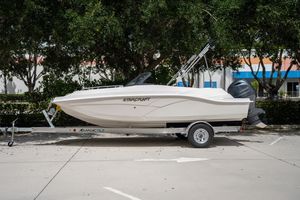 Starcraft SVX 190 OB 2022 Starcraft SVX 190 DC boat on trailer, parked outdoors, side view.