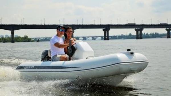 Grand Inflatables S330 2024 Grand Inflatables S330 boat cruising on a river with two people.