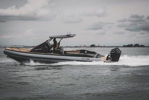 SPX RIB 38 2024 SPX RIB 38 boat cruising on open water under cloudy skies.