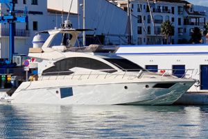 Cranchi Fifty 8 fly Luxury 2013 Cranchi Fifty 8 Fly yacht docked in a marina, with modern architecture backdrop.