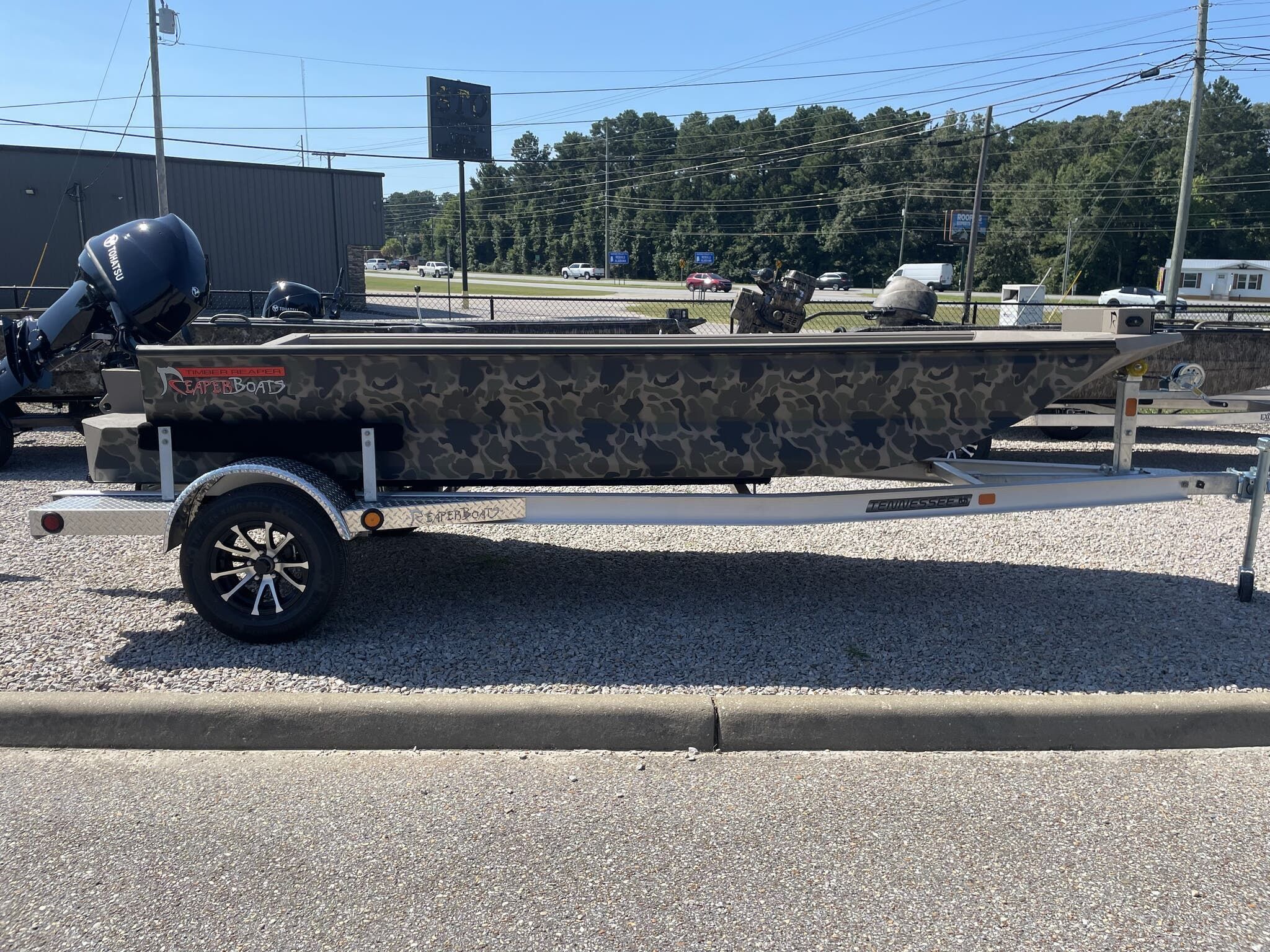 Reaper Boats 756 756 STEP TRANSOM 2025 Reaper Boats 756 STEP TRANSOM with camouflage design on a trailer.