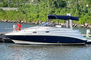 Regal Commodore 2665 2005 Regal Commodore 2665 boat docked on a calm river with lush greenery.
