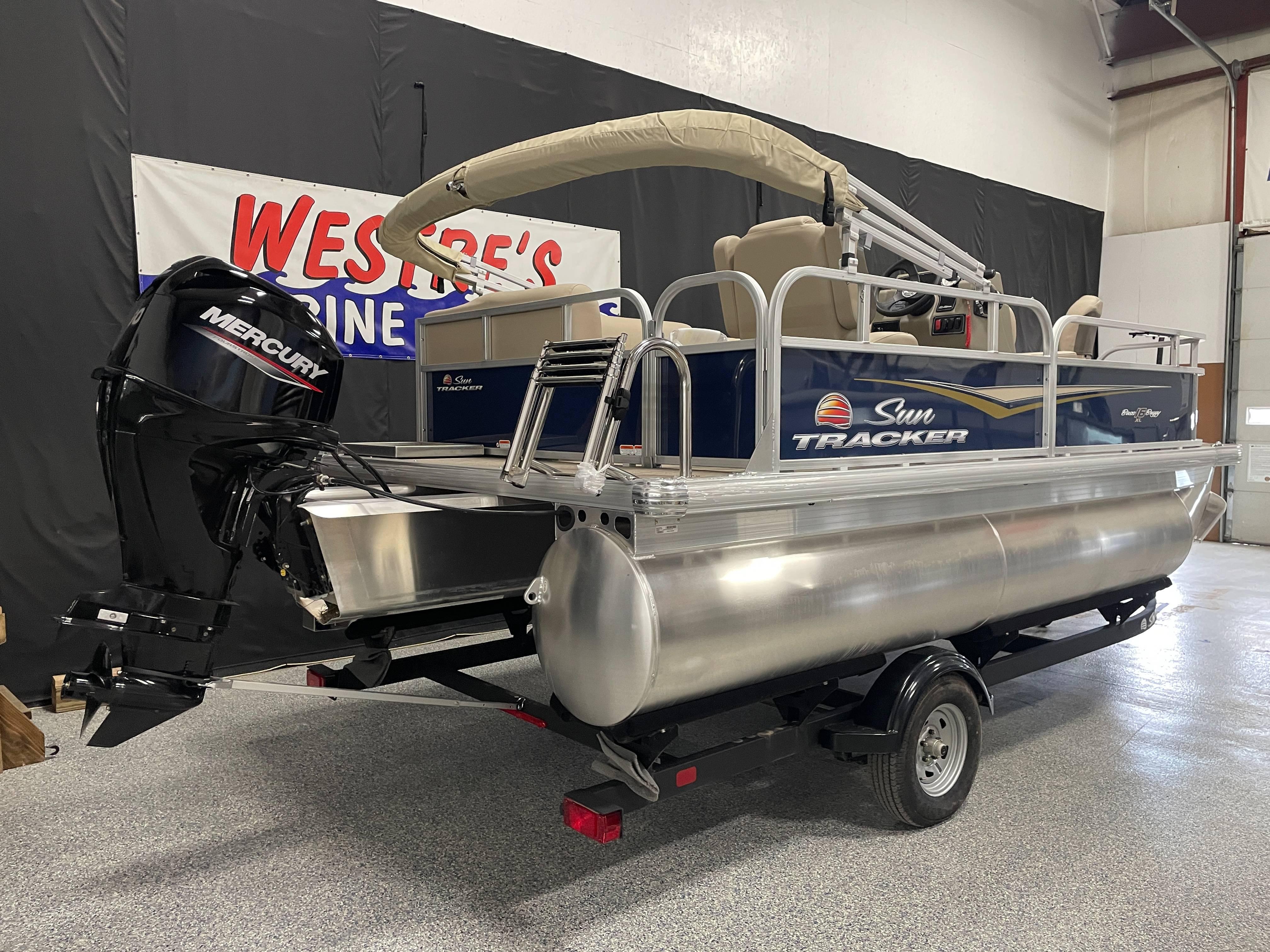 Sun Tracker Bass Buggy 16 XL Select 2025 Sun Tracker Bass Buggy 16 XL Select pontoon boat with Mercury engine in showroom.