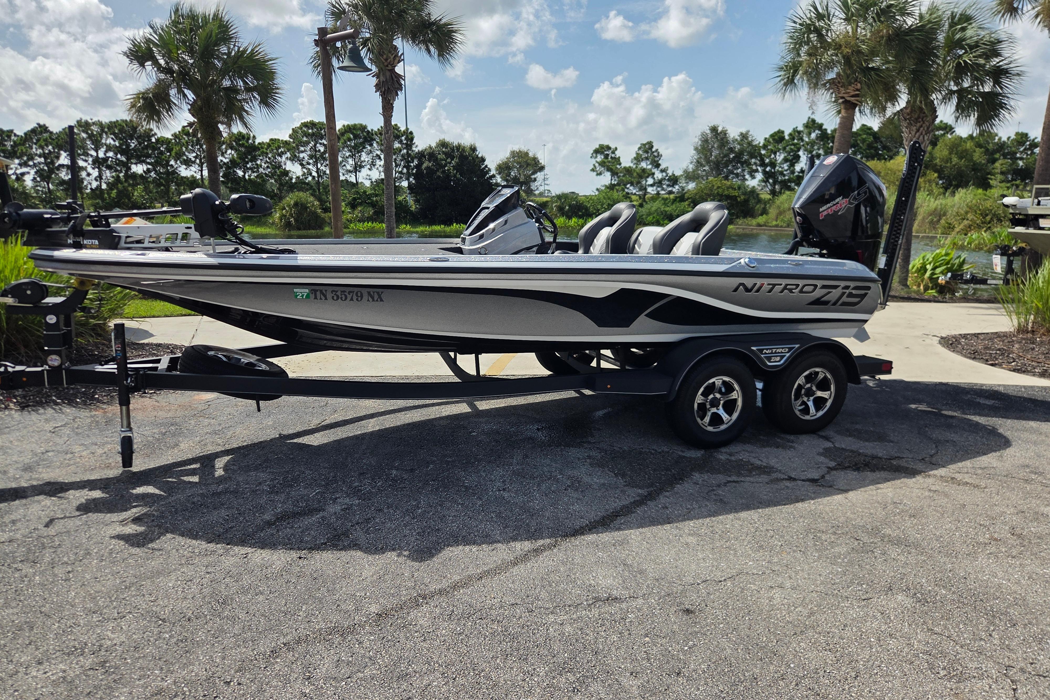 Nitro Z19 Pro 2023 Nitro Z19 Pro boat on trailer, parked near palm trees under a sunny sky.