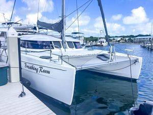 Fountaine Pajot Lipari 41 2014 Fountaine Pajot Lipari 41 catamaran docked, named "Breathing Room," under a clear blue sky.
