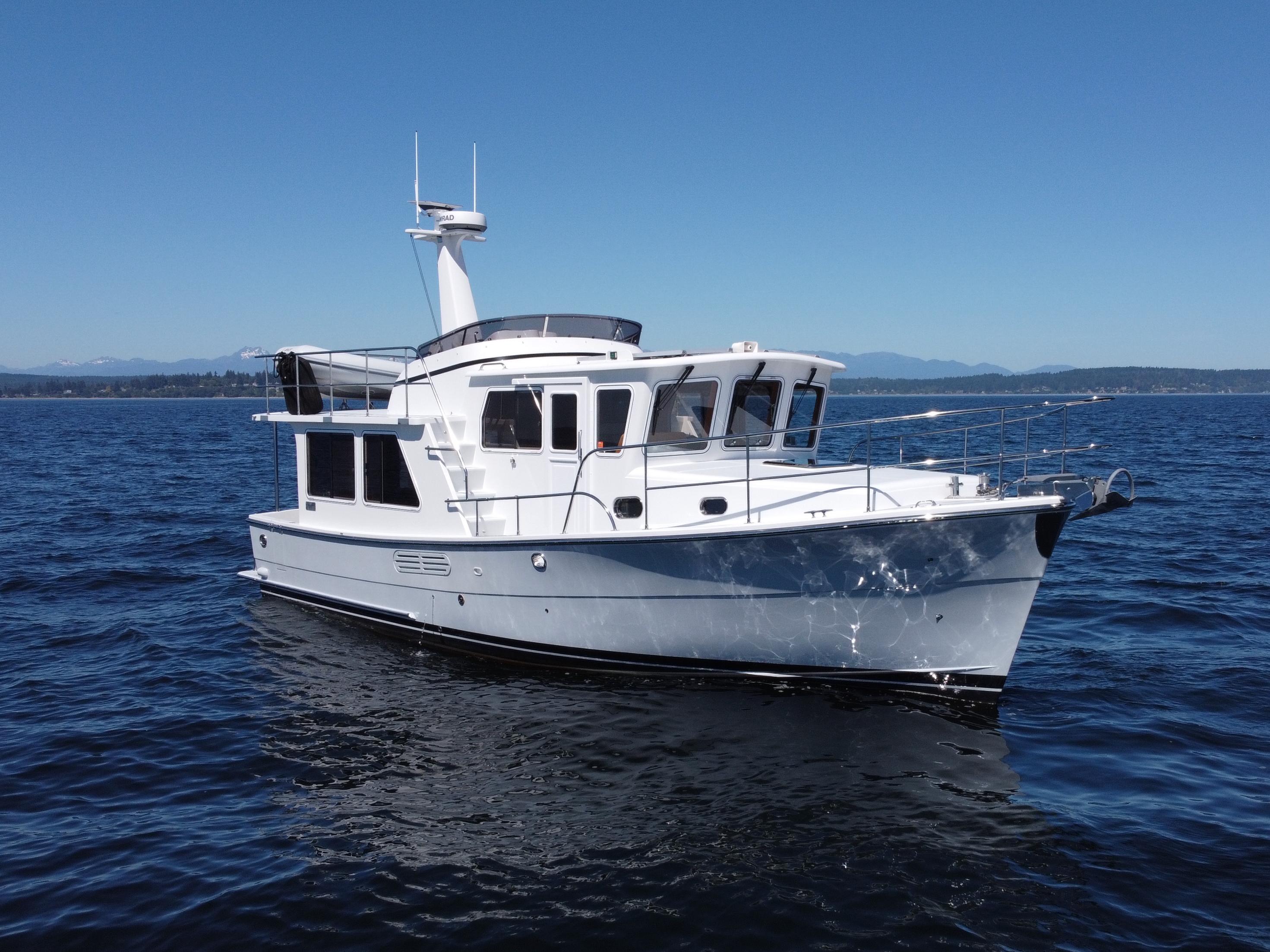 Helmsman Trawlers 38E 2019 Helmsman Trawlers 38E cruising on open water under clear blue skies.