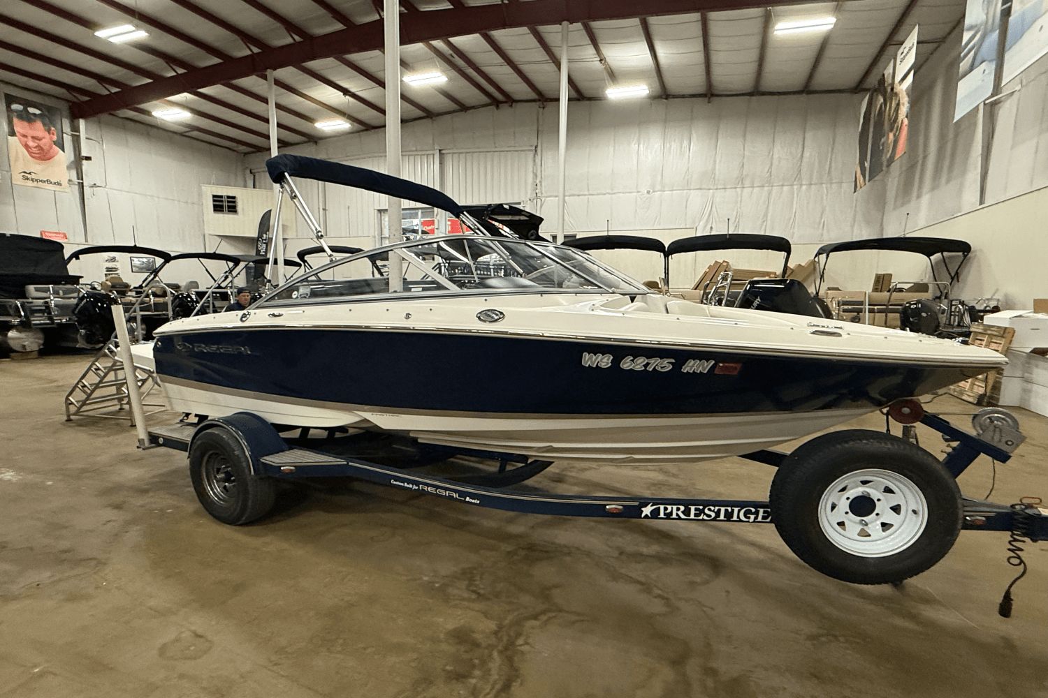 Regal 1900 2008 Regal 1900 boat on trailer in indoor showroom setting.