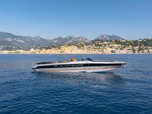 Custom MC 30 2024 Custom MC 30 speedboat cruising on blue waters with scenic coastal backdrop.